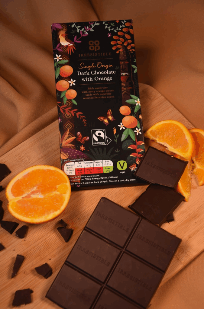 COOP Orange Chocolate product shoot. ornges and the chocolate around the product with a chopping board to add texture against a orange silk backdrop